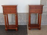 two wooden tables with drawers on each side of them