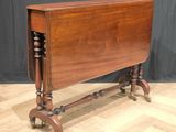 an old wooden table with wheels on a hard wood floor