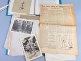 a lot of old papers and pictures on the table