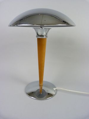 an image of a table lamp on a white surface with a cord plugged to it