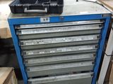 a blue tool cabinet with a green tray on top of it