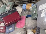 a pile of blankets, blankets, and blankets in a shopping cart