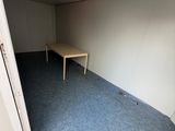 an empty room with a table and a chair in it