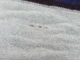 a close up of a white sweater with a blue stripe on it