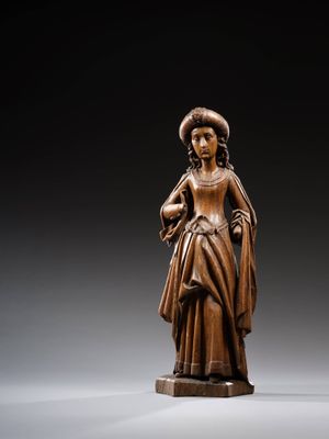 an image of a wooden statue of a woman holding a bird