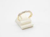 a white and yellow gold ring with diamonds on a white surface