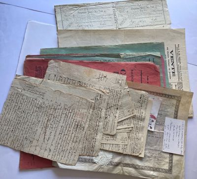 some old papers are sitting on top of each other on a table