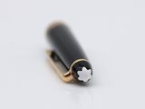 a pen that is laying on a white surface