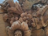 a wooden carving of a bird and flowers on a table