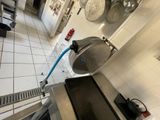 an image of a commercial kitchen with a lot of pots and pans on the wall
