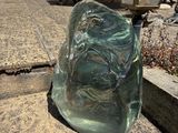 a glass object on the ground next to a lamp
