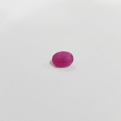 a pink oval stone on a white surface