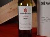 a bottle of wine sitting on a table next to a box of wine