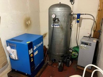 a water heater and a refrigerator in a small room