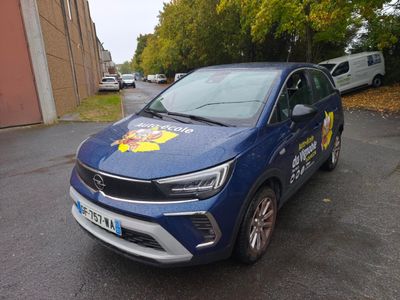 a blue car that is parked on the side of the road