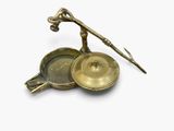 a small brass object that is on a white surface