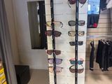 many pairs of sunglasses on display in a store