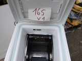 a white cooler with a black lid sitting on a box