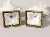 pair of white porcelain figurines of a woman and a man