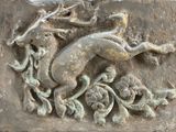 a stone plaque with a horse and a bird on it