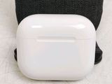 a white airpods with a green dot on it
