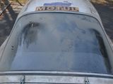 a dirty car with a sticker on the hood