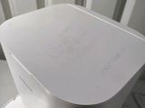 a close up of a white toaster on a counter