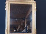 a mirror that is sitting on a wooden stand