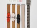 four different types of watches on a white surface