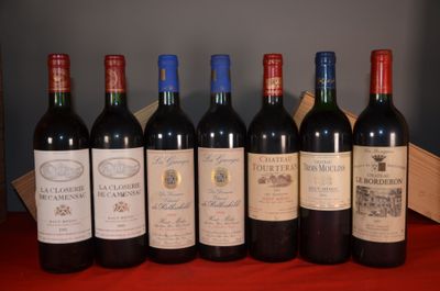 six bottles of wine are lined up on a red table