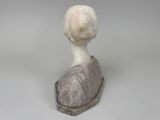 a statue of a woman sitting on top of a rock