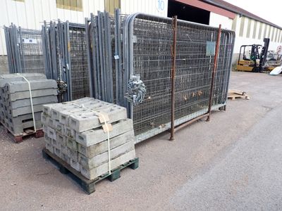many stacks of concrete blocks on a pallet in front of a building