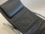 an image of a black leather chaise lounger on chrome legs