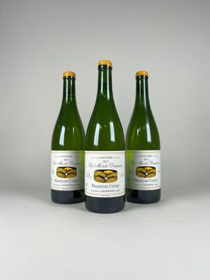 three bottles of wine sitting next to each other on a table