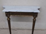 a marble top table with a gold frame on it