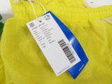 a yellow bag with a label on it and a green bag with a price tag on it