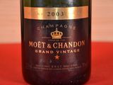 a bottle of champagne sitting on a red cloth