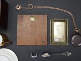 a table with a wooden box, a plate, a spoon, and other items on it