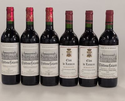 six bottles of wine are lined up on a table