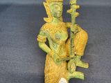 figurine of a woman holding a musical instrument in her right hand