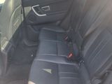 the back seat of a car with a black leather seat cover