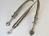 pair of antique silver plated swords on a white background