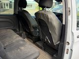 a white van with two black seats in the back of it