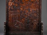 an antique carved wooden screen with birds and flowers on it