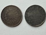 an old and a new one cent coin on a white surface