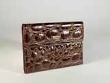 a brown leather wallet with a chain on the front