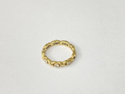 a close up of a gold ring on a white surface