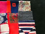 many different types of ties laid out on a black surface