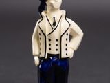 a small figurine of a man in a suit and hat