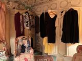a room with a lot of clothes hanging on the wall